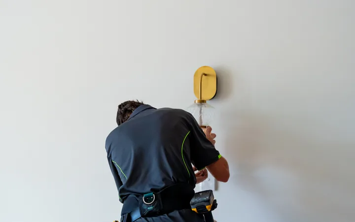 Electrician finishing an outlet at floor level