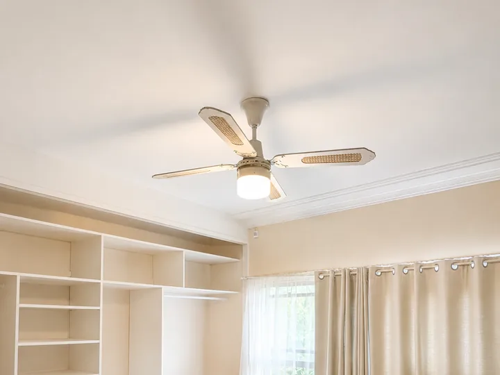 Older cane-bladed ceiling fan due for replacement