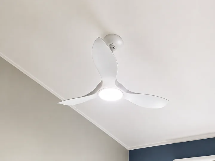 Ceiling fan mounted on a raked ceiling with an angled adapter