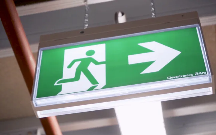 Illuminated emergency exit sign installed and tested