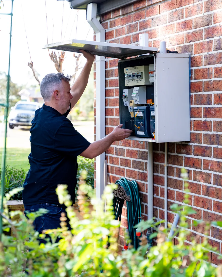 Electrician opening an outdoor meter enclosure