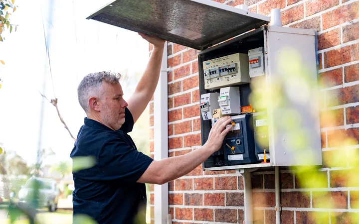 Electrician working on the meter enclosure