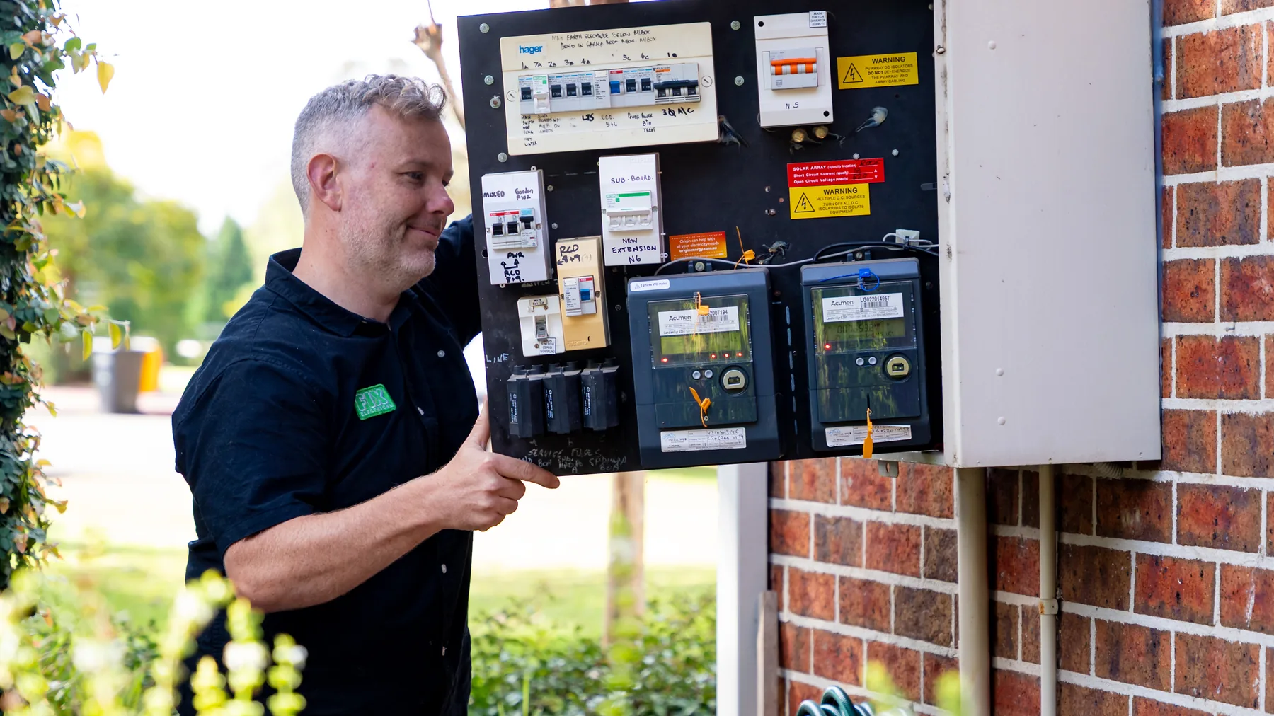 Electrician working on an outdoor meter and switchboard