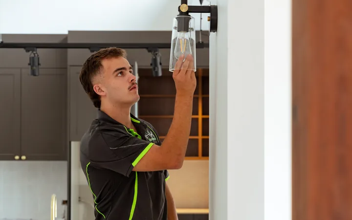 Electrician servicing a pendant fitting