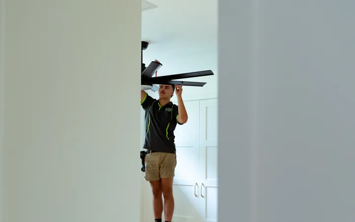Electrician working on a ceiling fan