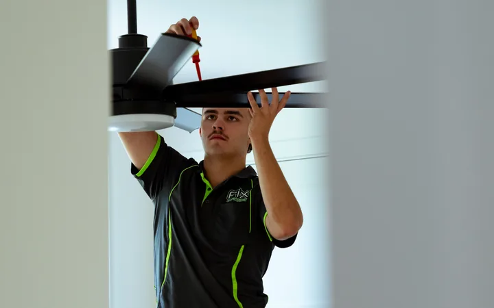 Electrician completing a ceiling fan install