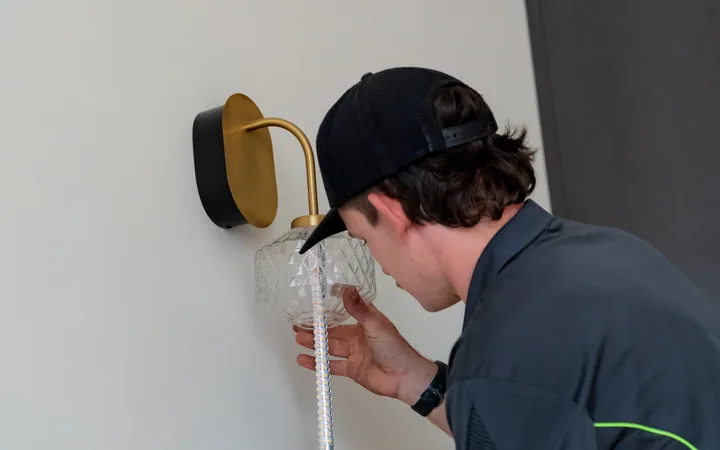 Electrician completing a wall light